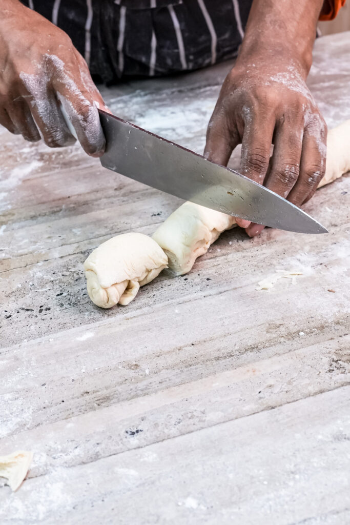 Cutting kouign amann dough