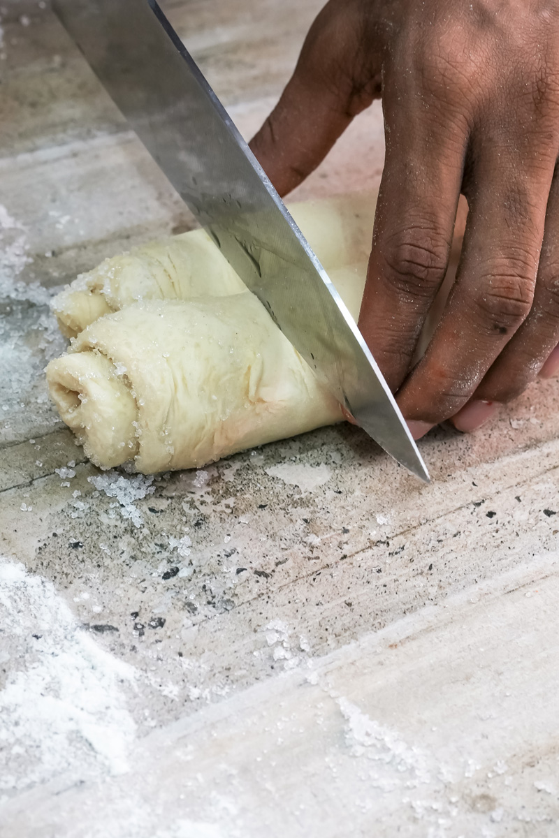 Cutting palmiers dough log with sharp knife
