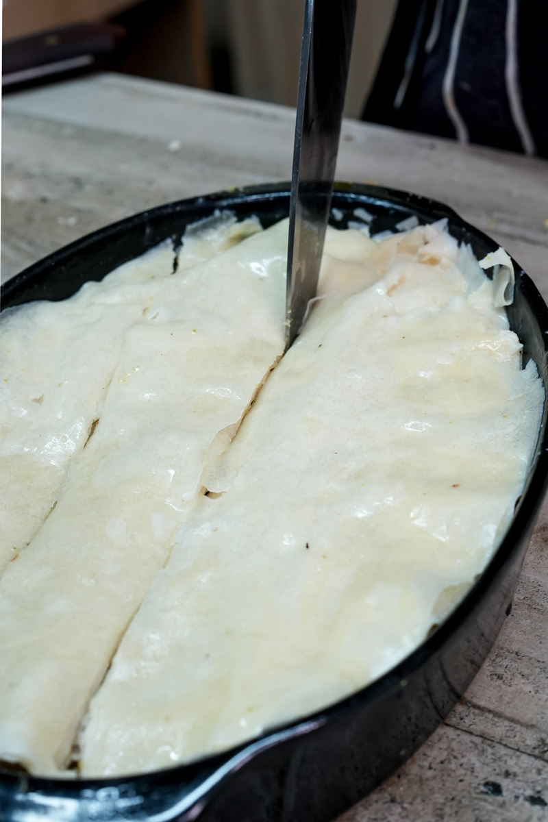 Cutting phyllo dough layers for baklava recipe