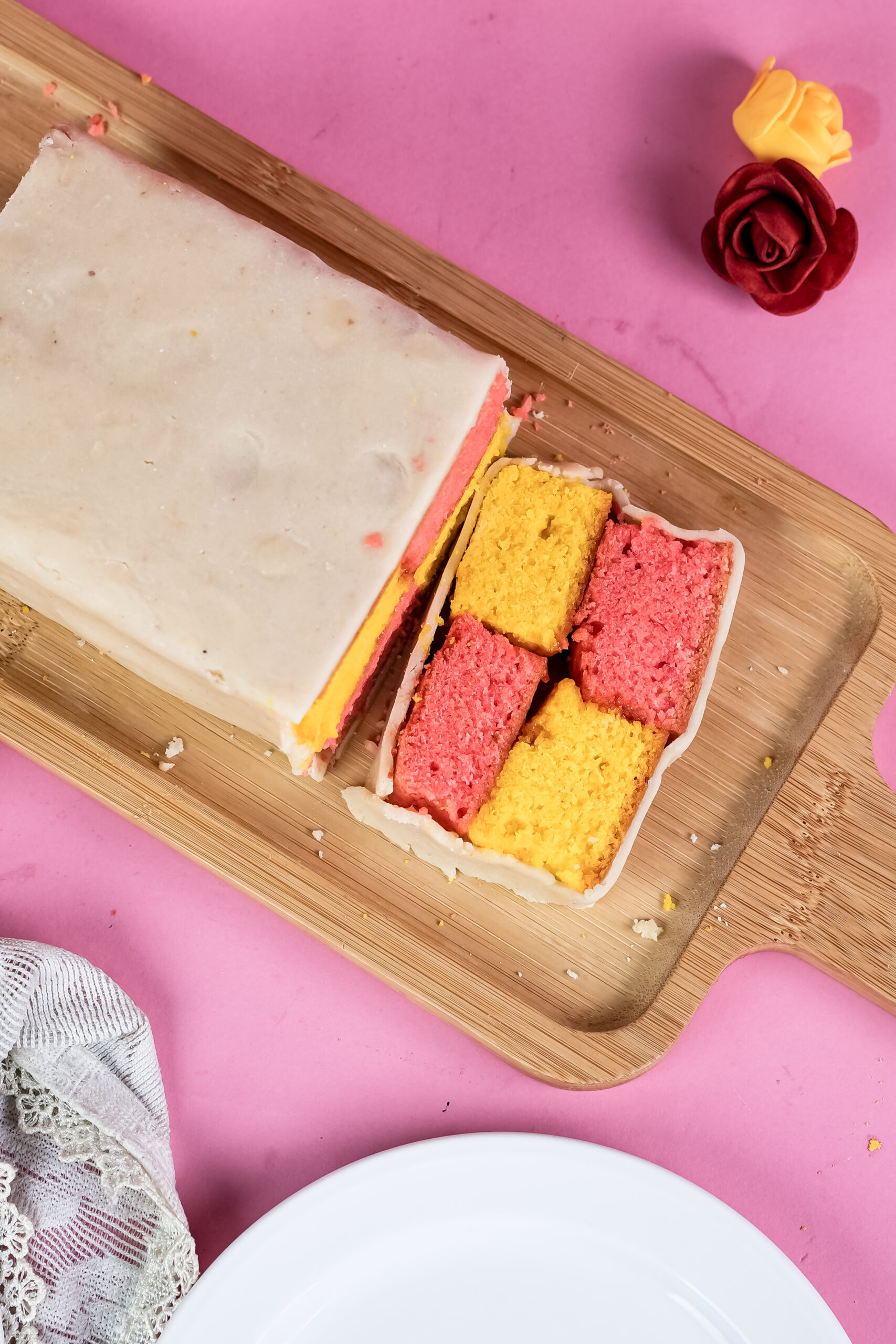 Battenberg cake portions on cutting board showing internal structure