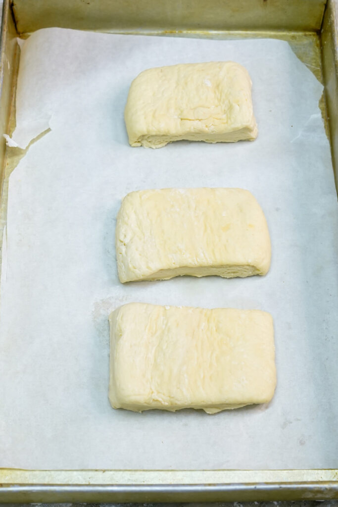 Danish pastry rectangles on parchment-lined baking sheet