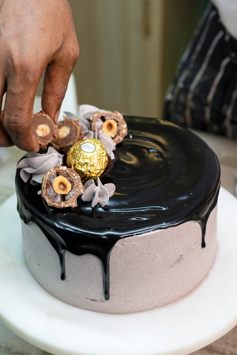Decorating Ferrero Rocher cake with chocolates and ribbon bow