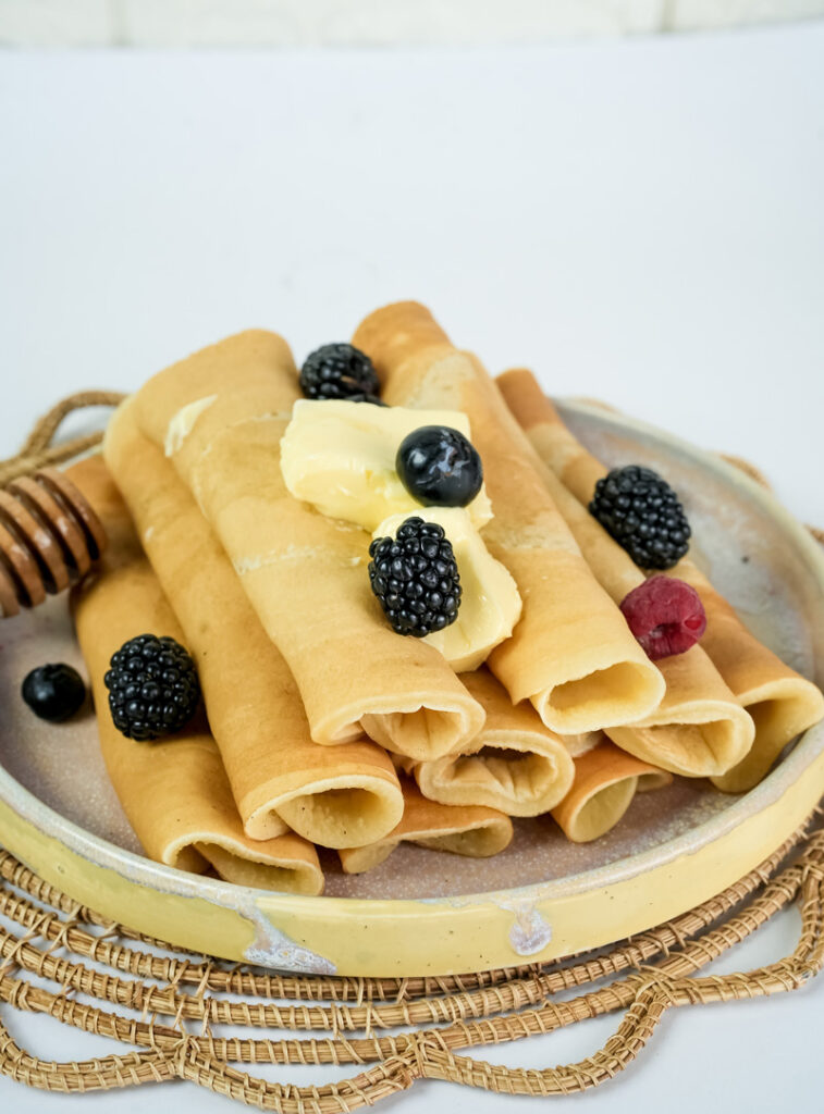 Traditional pancake rolls with blackberries, blueberries and raspberry