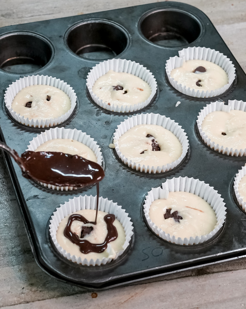 Drizzling melted Nutella over muffin batter