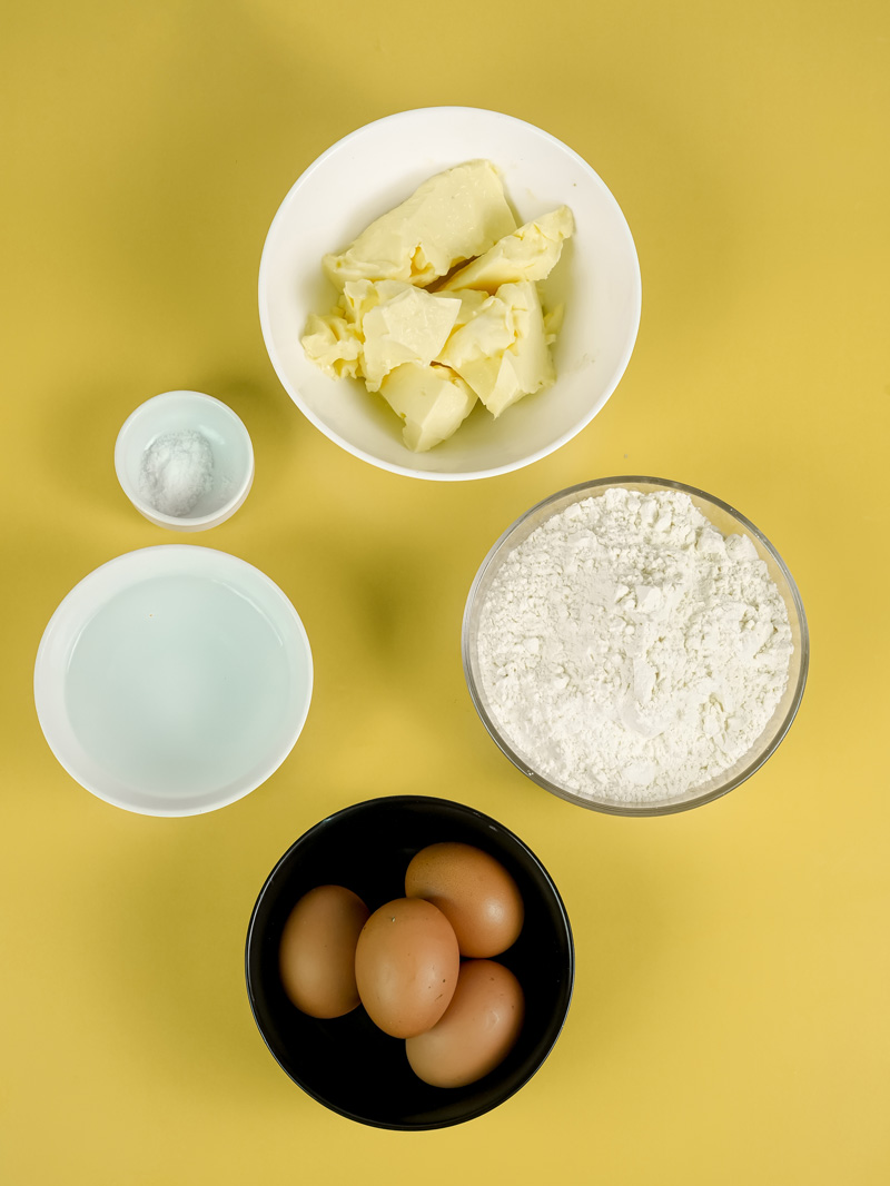 Eclair ingredients: butter, flour, eggs, salt and milk for choux pastry dough