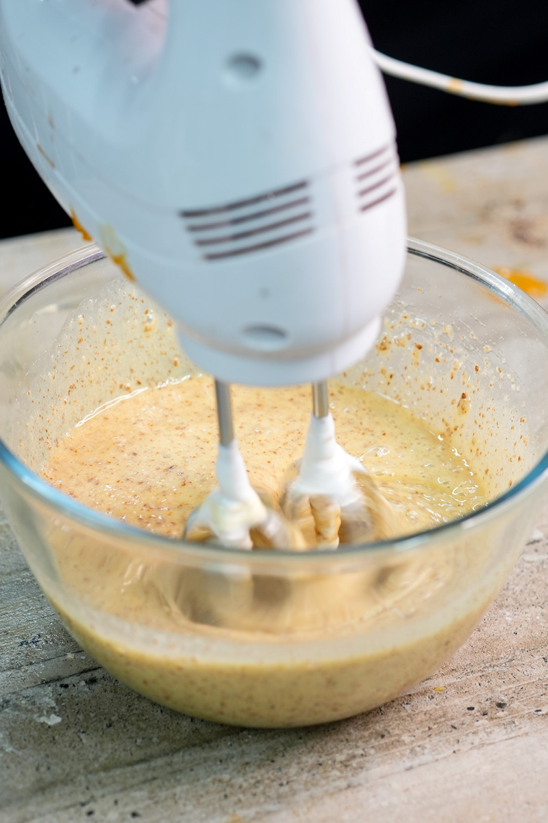 Electric mixer whipping opera cake batter to proper consistency