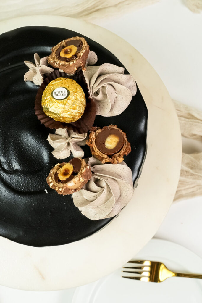 Top view of Ferrero Rocher cake showing chocolate decorations and gold foil