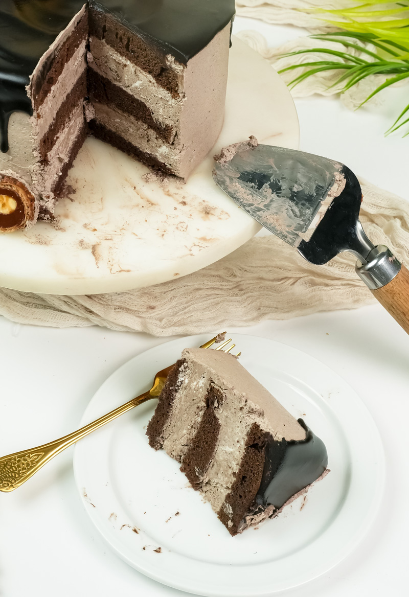 Ferrero Rocher cake slice on server showing three chocolate layers