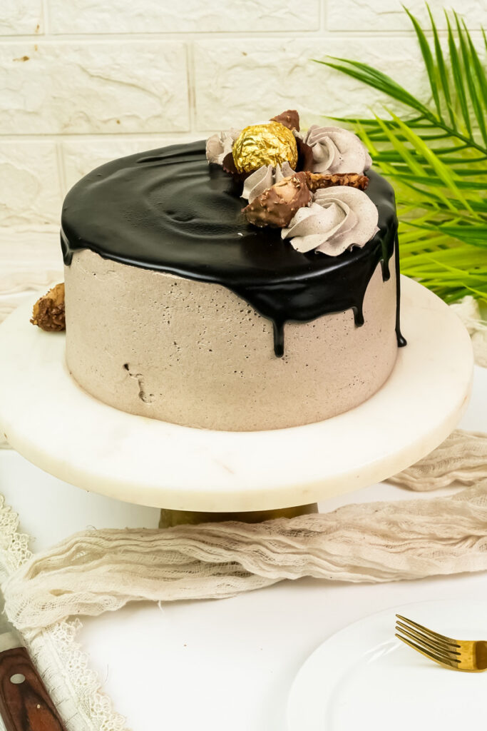 Ferrero Rocher cake with glossy chocolate drip and hazelnut chocolates