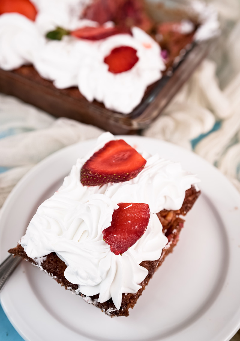 Final slice of strawberry earthquake cake on white plate