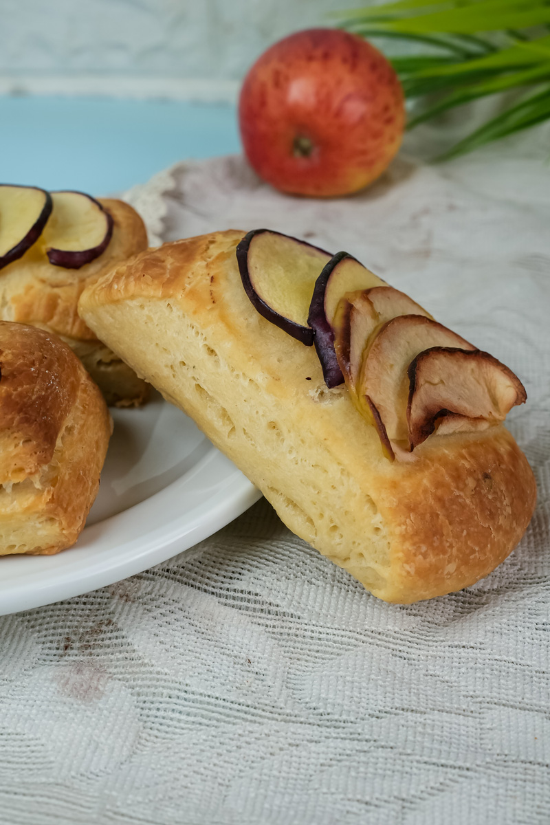 Flaky Danish pastry with apple slices close-up