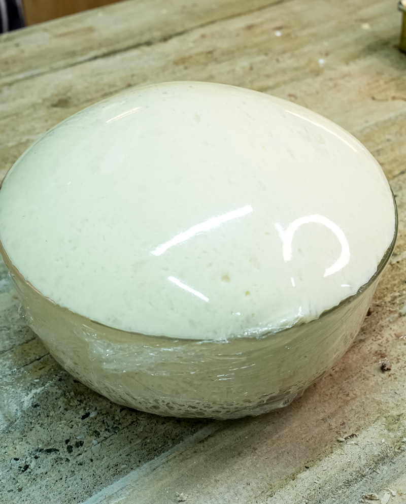 Focaccia dough rising in glass bowl