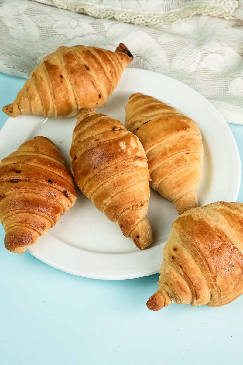 Fresh baked raisin croissants arranged on serving platter