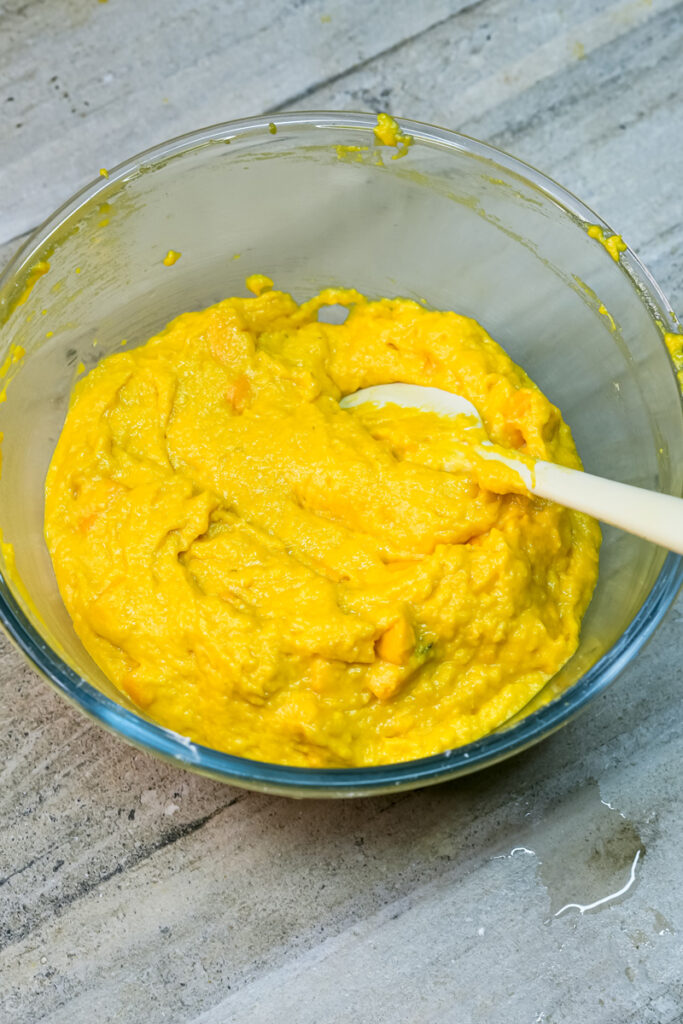 Fresh mango puree in mixing bowl for mango muffins