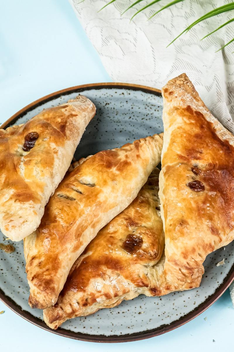 Freshly baked golden apple turnovers on plate