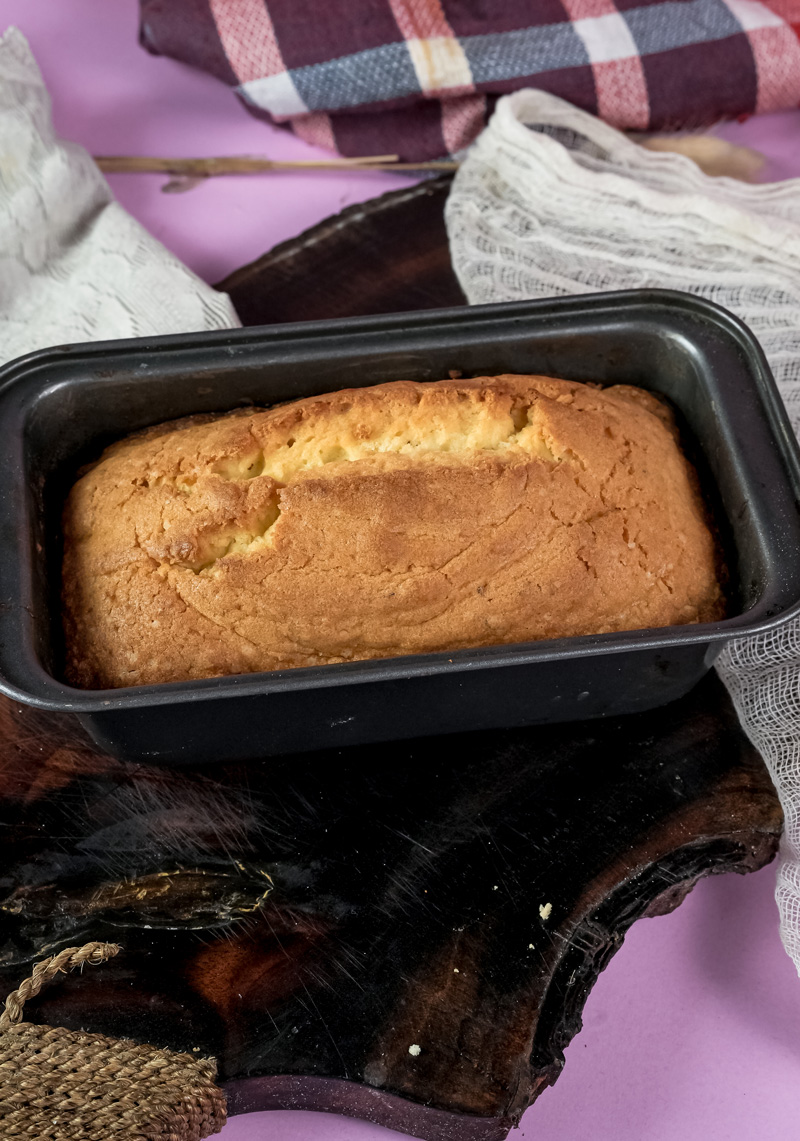 Golden Madeira cake in loaf pan fresh from oven