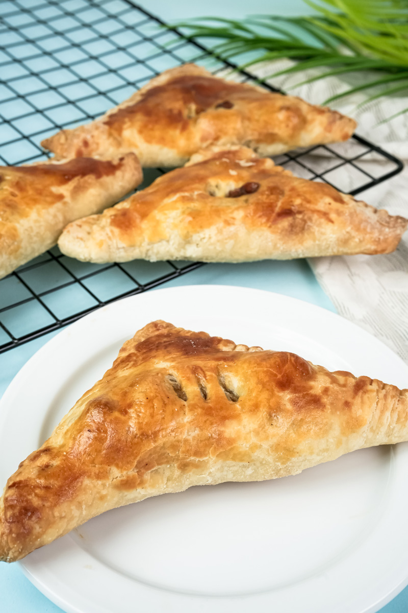 Golden baked apple turnovers cooling on wire rack