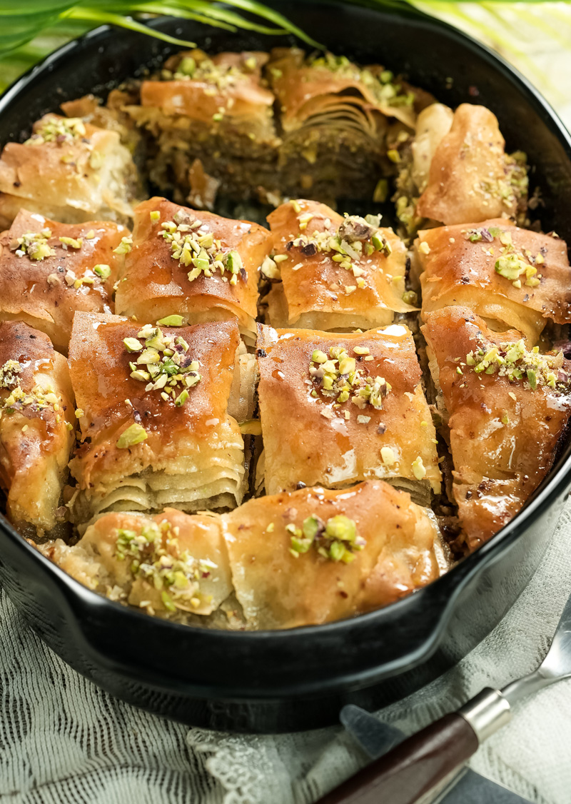 Golden baklava pieces topped with crushed pistachios