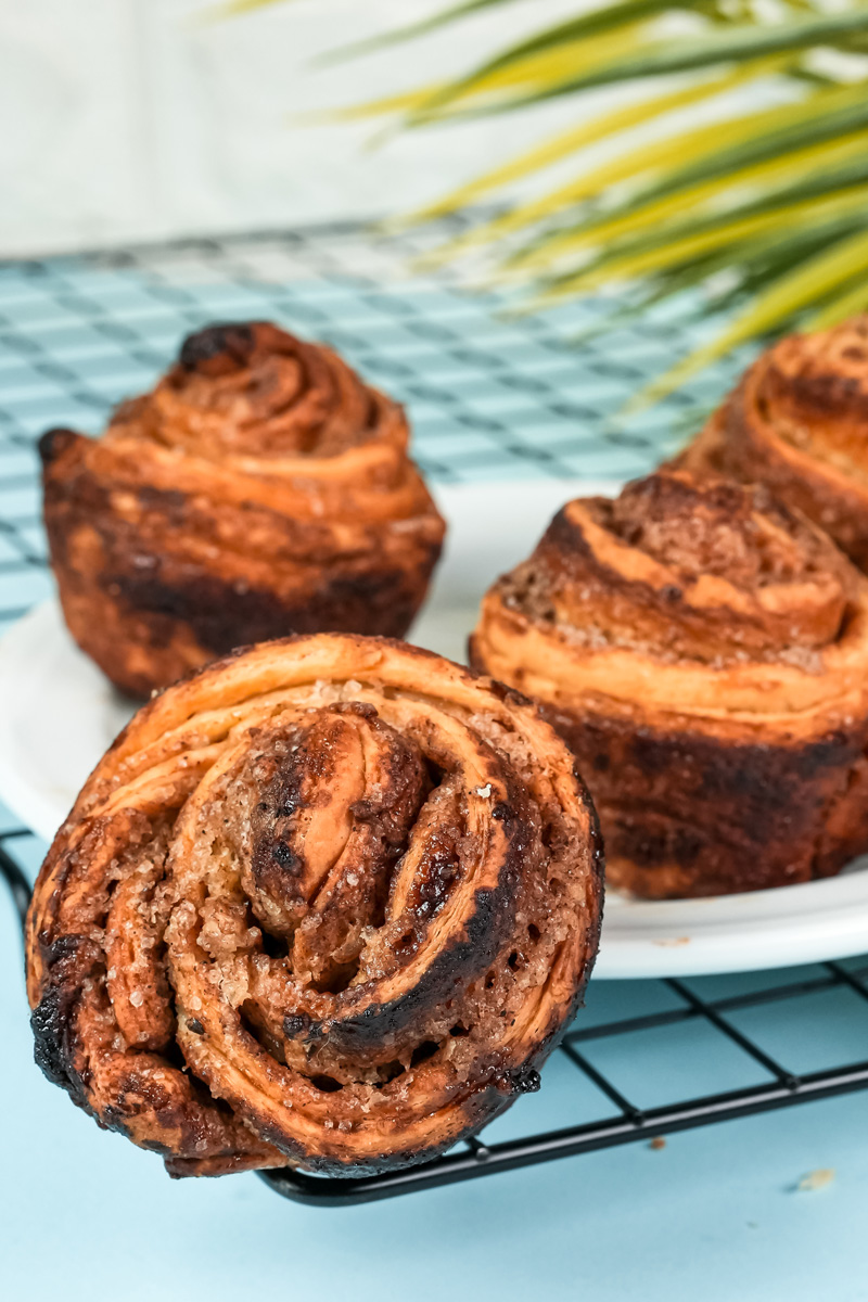 Golden brown homemade cruffins with flaky layers on cooling rack