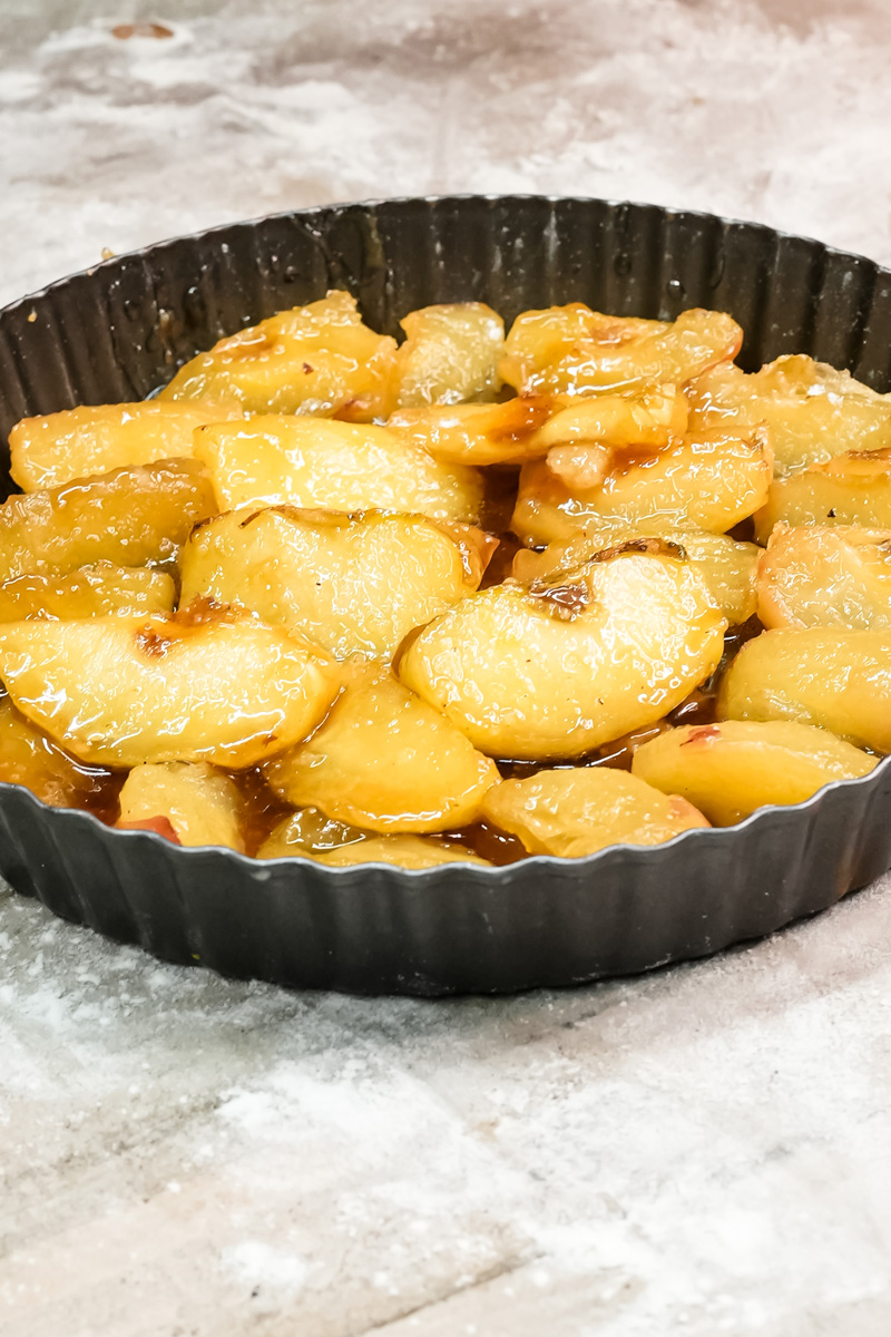Golden caramelized apples ready for pastry layer in Tarte Tatin