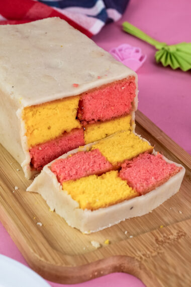 Homemade Battenberg cake sliced to show pink and yellow pattern