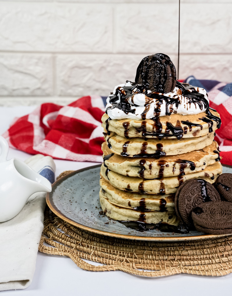 Homemade Oreo pancakes with whipped cream and chocolate syrup