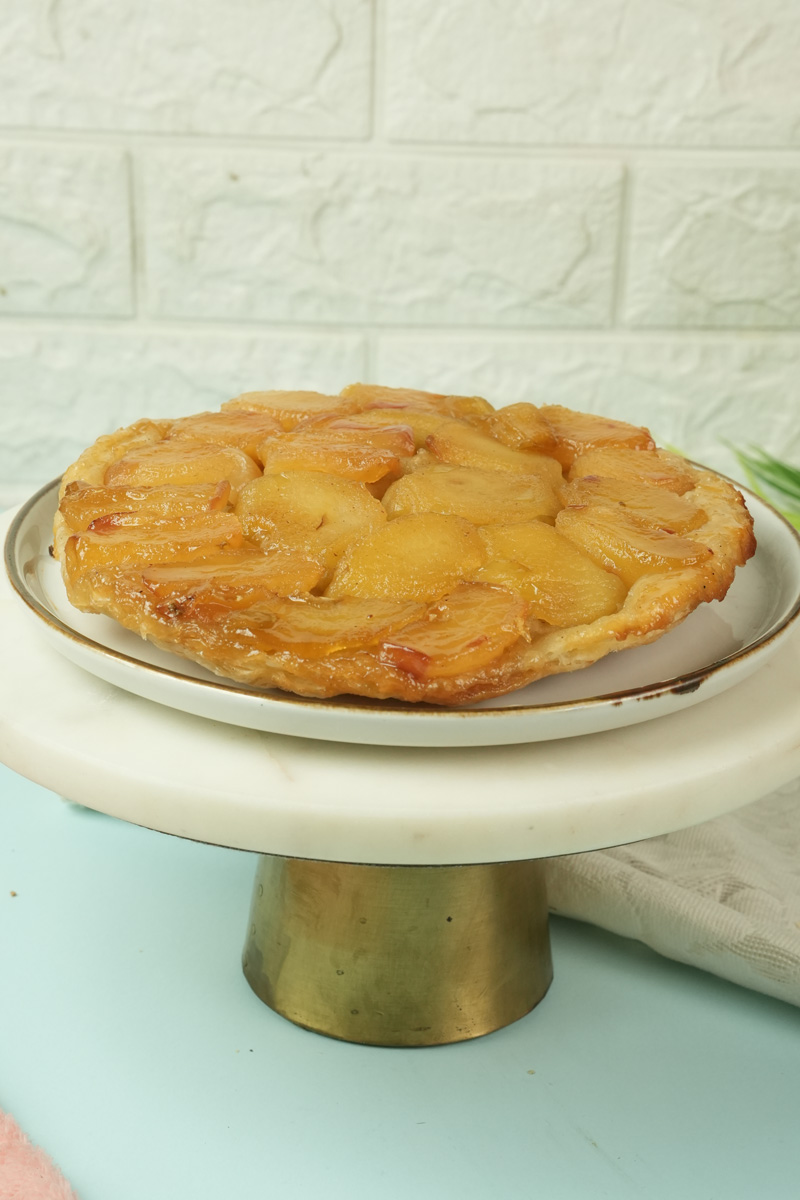 Homemade Tarte Tatin on white cake stand