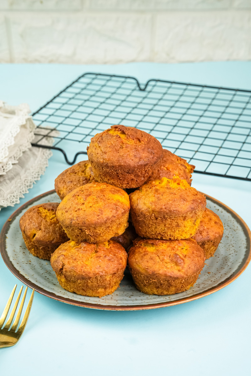 Homemade mango muffins cooling on wire rack