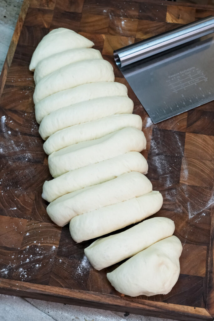 Portioned Korean bun dough pieces on cutting board