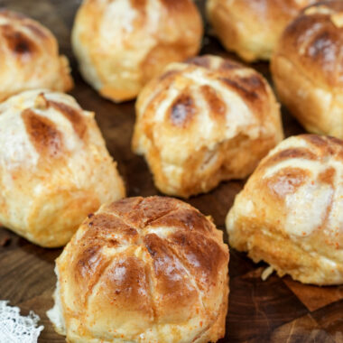 Korean buns with golden cross pattern on wood surface