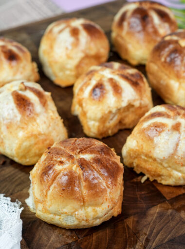 Korean buns with golden cross pattern on wood surface