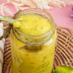 Lemon curd on spoon showing thick creamy consistency