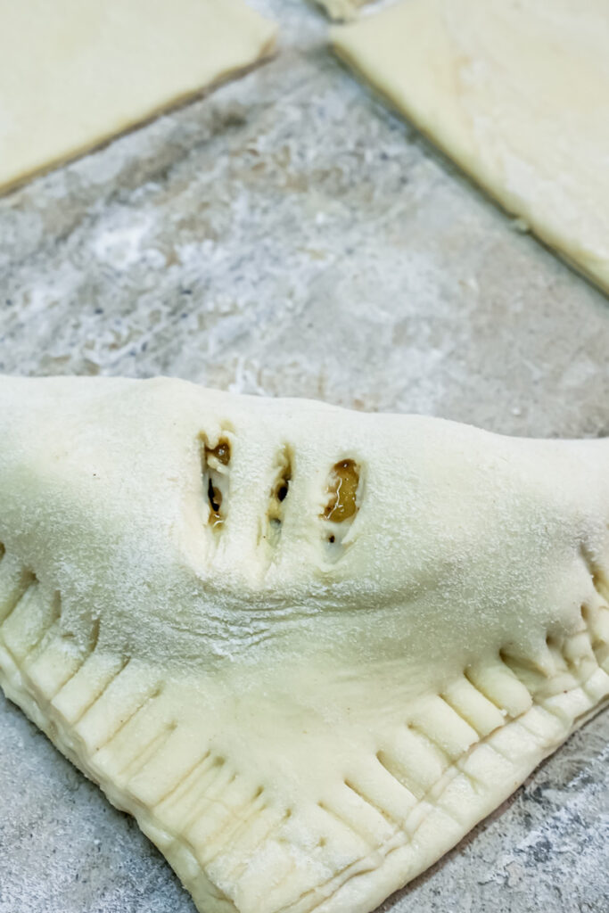 Making steam vents in apple turnover with knife