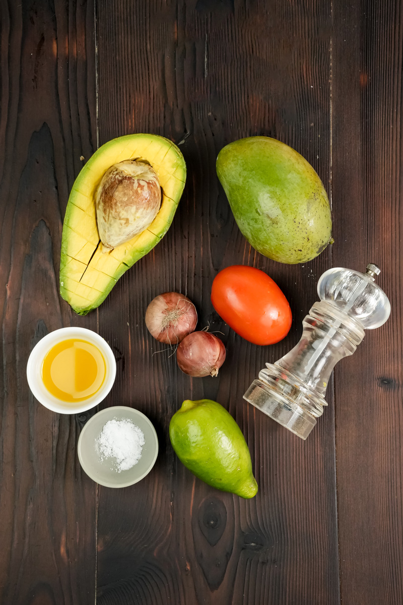 Mango avocado salad ingredients - avocado, mango, tomato, lime, olive oil