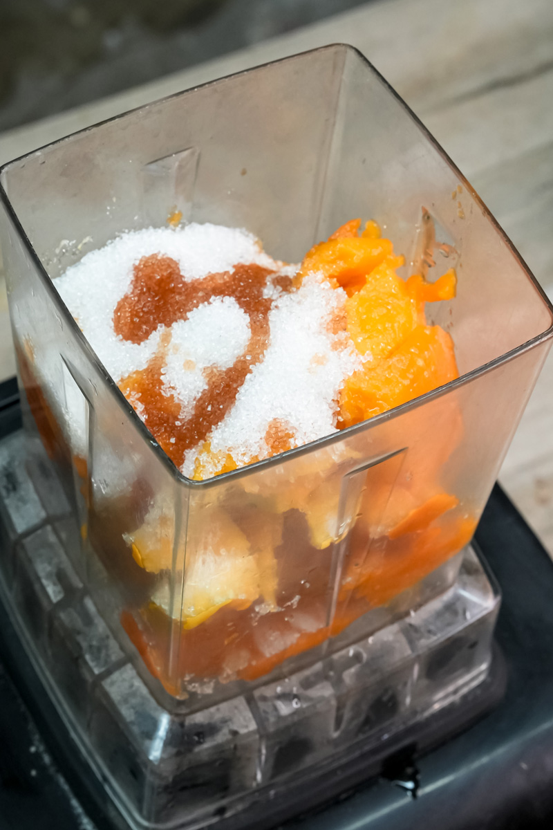 Mango chunks with sugar in blender for milkshake recipe