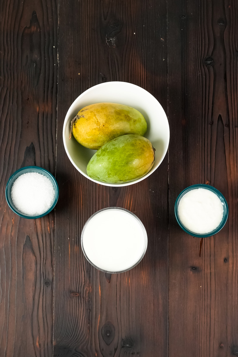 Mango lassi ingredients: fresh mangoes, milk, and sugar