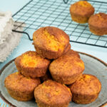 Final plated mango muffins with golden brown tops