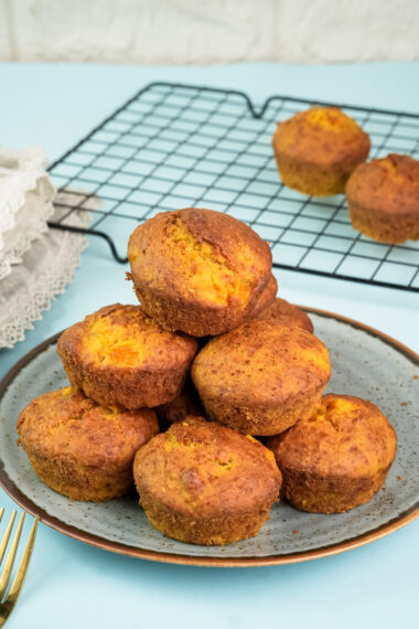 Final plated mango muffins with golden brown tops