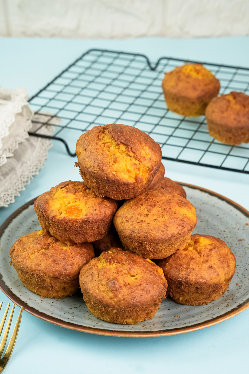 Final plated mango muffins with golden brown tops