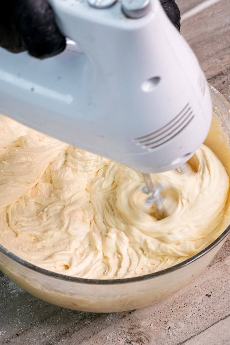 Mixing Battenberg cake batter with electric hand mixer
