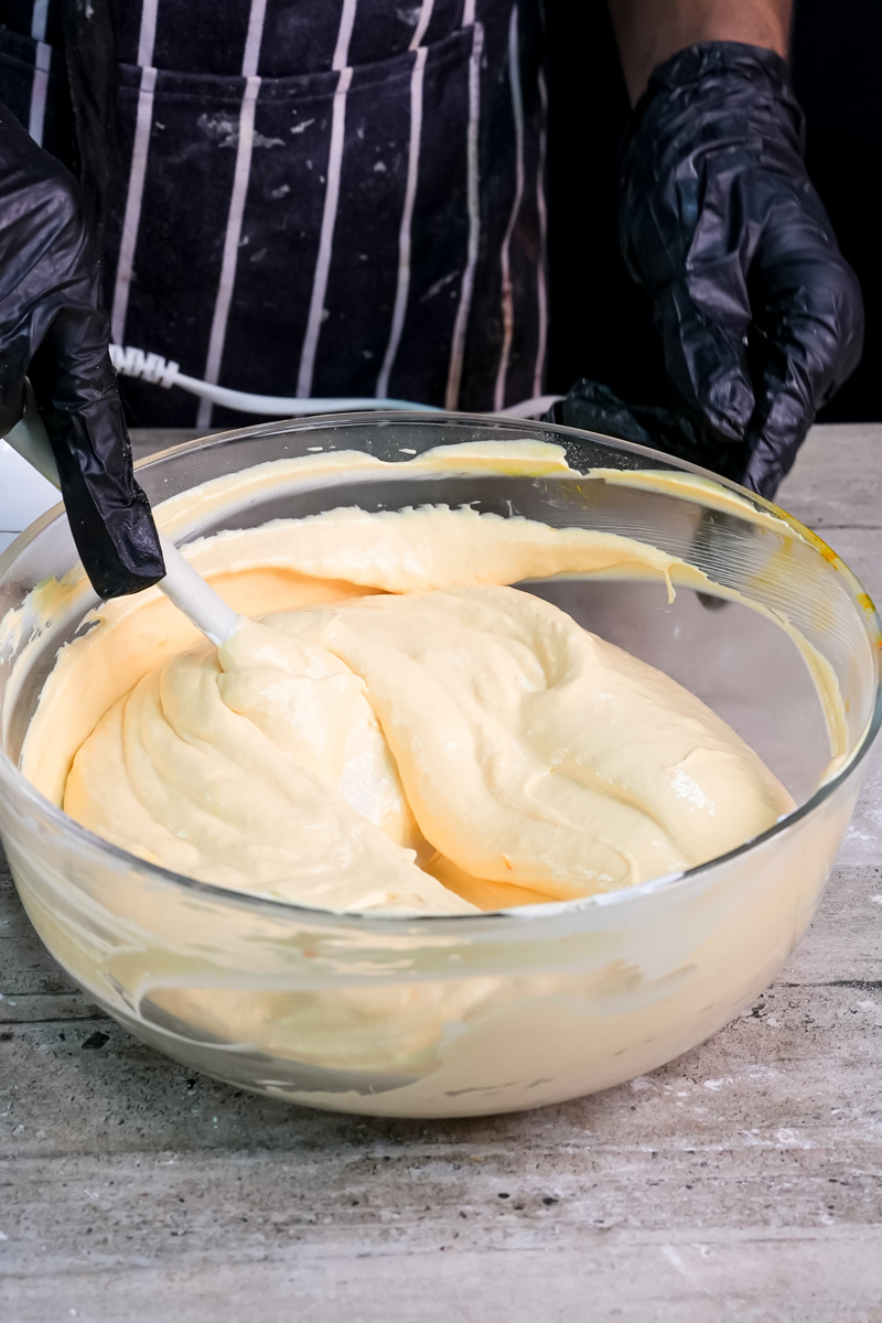 Mixing custard cream filling for charlotte cake with whisk