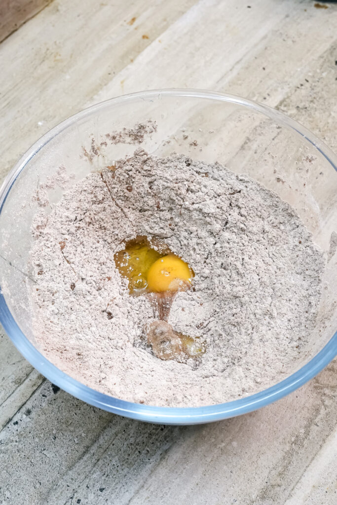 Mixing eggs into chocolate cake batter