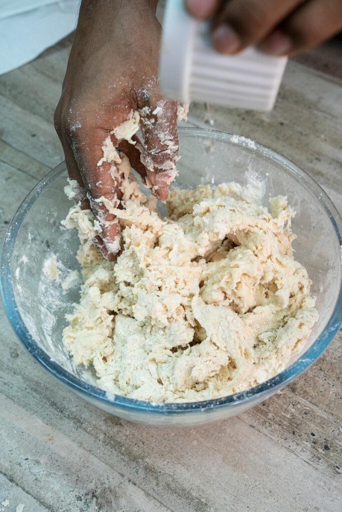 Mixing empanada dough ingredients by hand