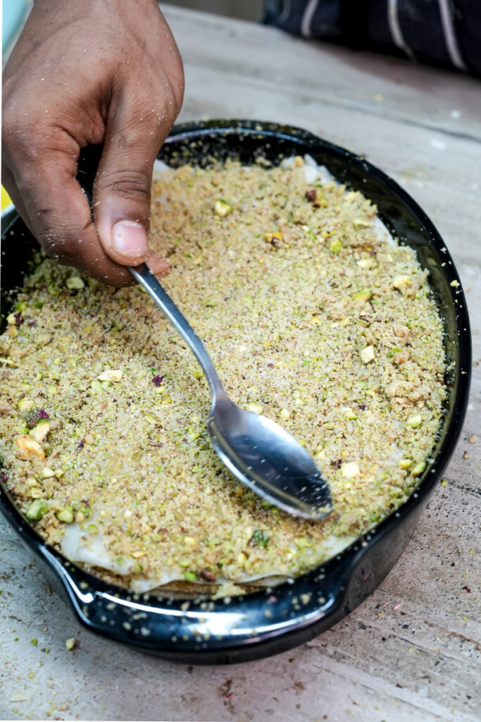 Mixing ground pistachios for homemade baklava filling