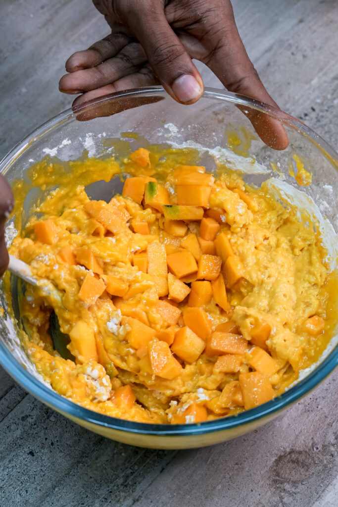 Mixing mango muffin batter by hand