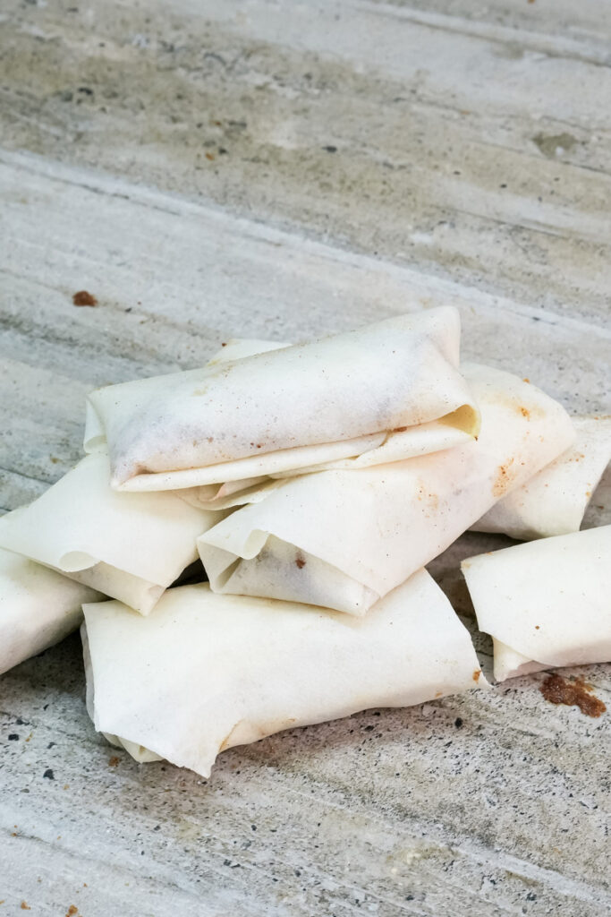 Multiple wrapped banana lumpia before cooking