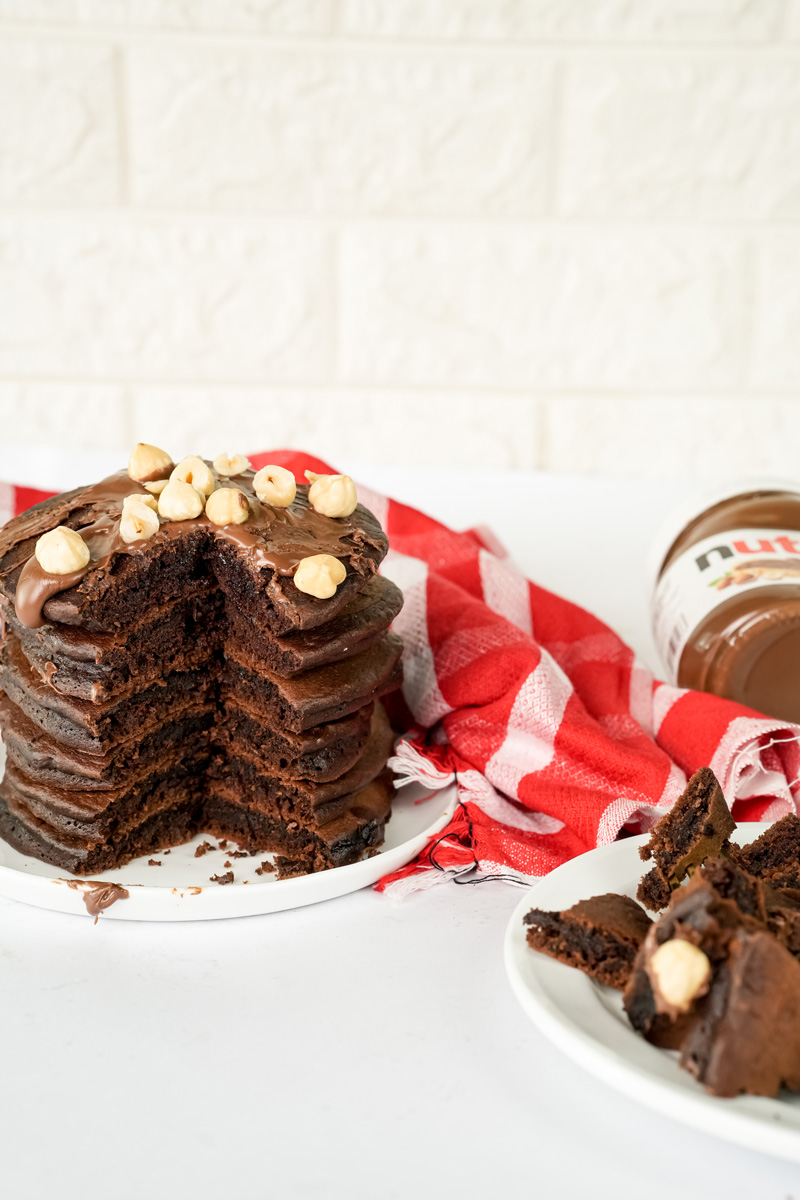 Sliced Nutella pancake stack showing fluffy chocolate layers