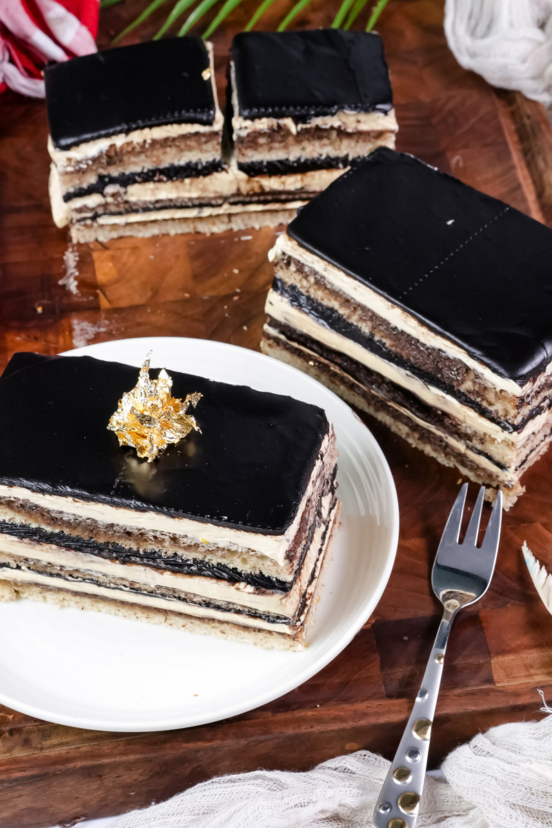 Opera cake slices with gold leaf garnish ready for serving