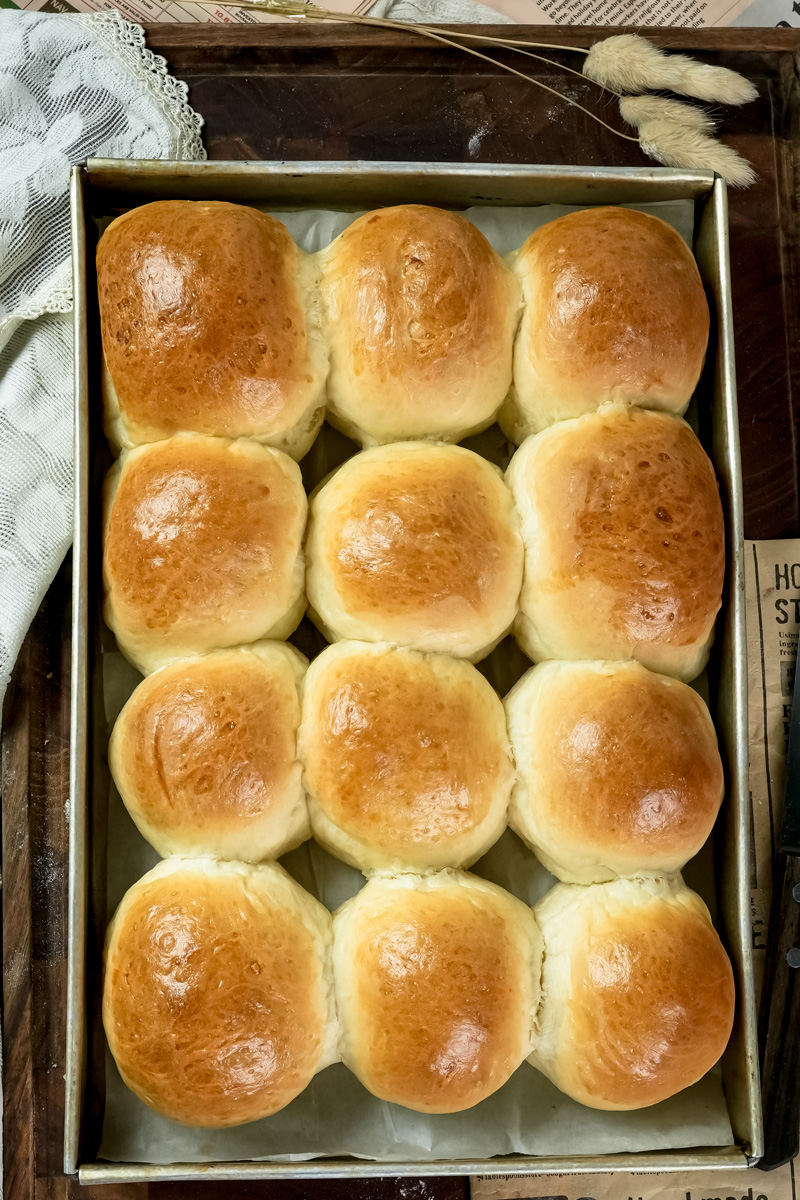 Perfectly golden buns cooling in pan