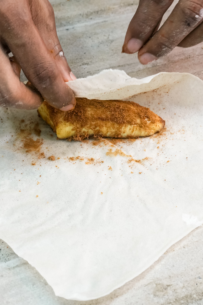 Placing seasoned banana on lumpia wrapper